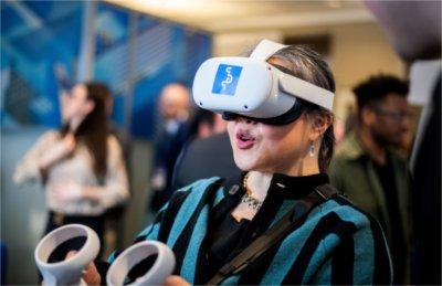 An attendee at the Reach Higher Showcase tries a virtual reality headset.